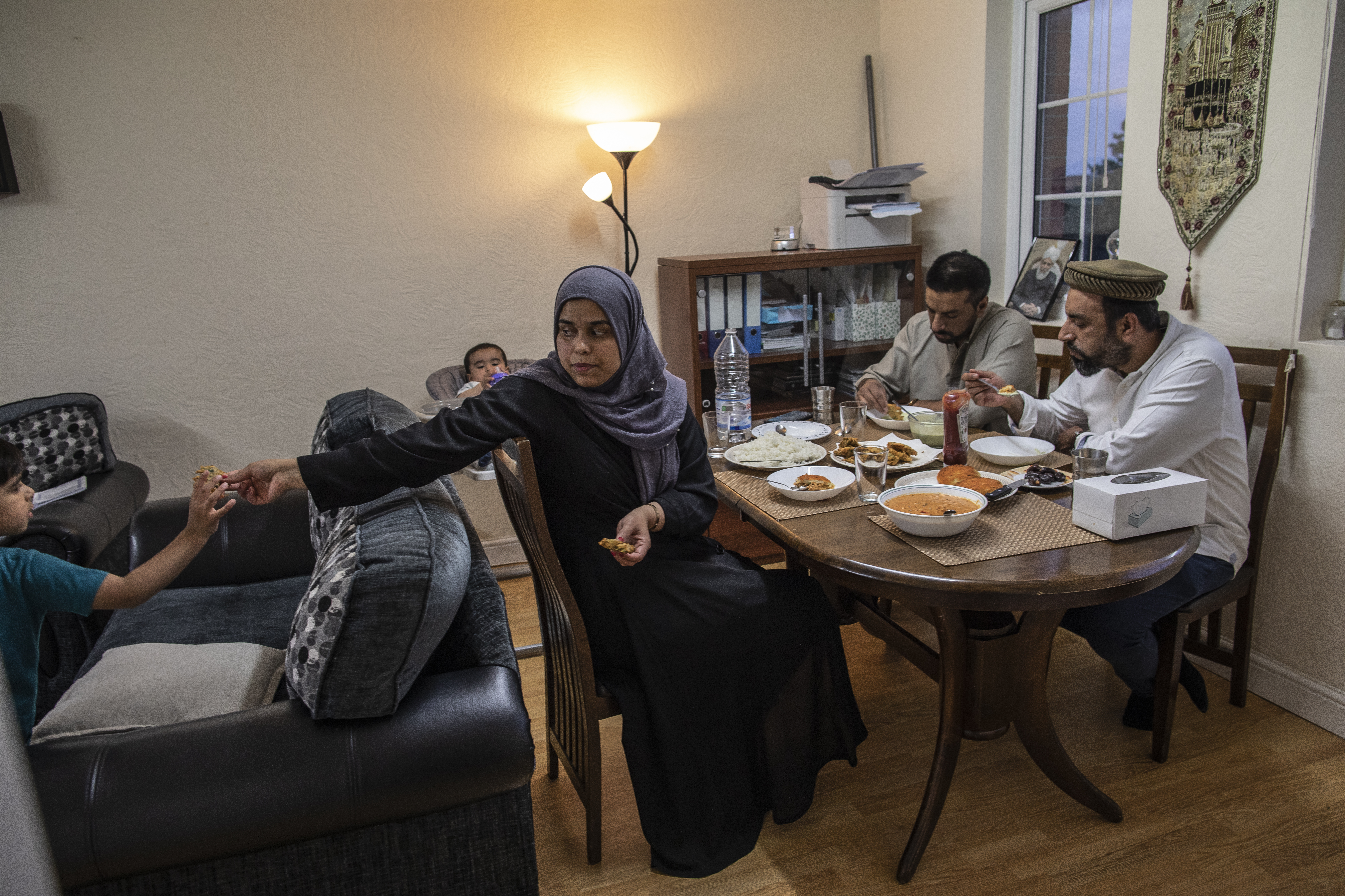 Muslim family having Iftar dinner at home during Ramadan lockdown.