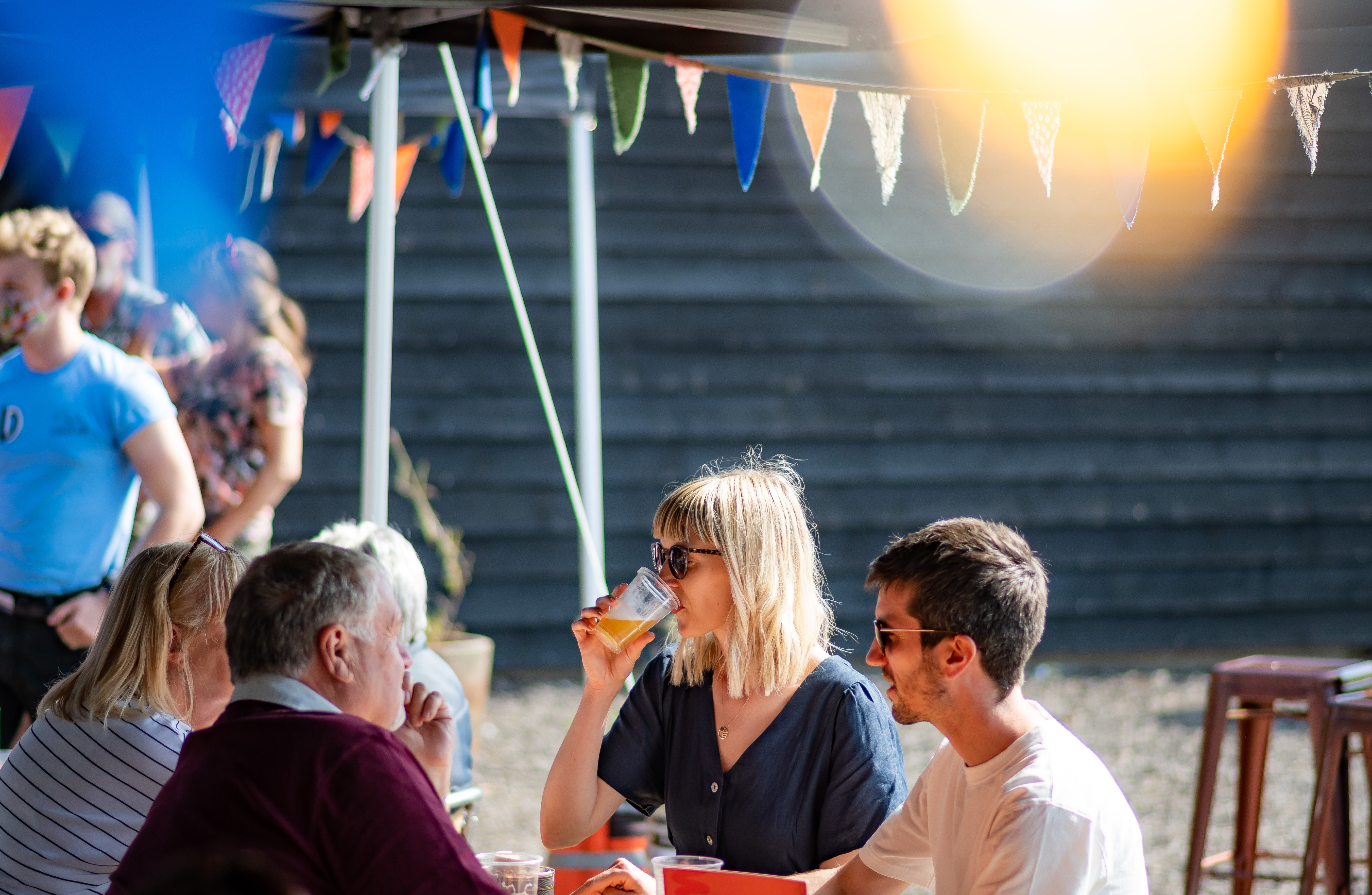Outdoor seating area with canopy and bunting.