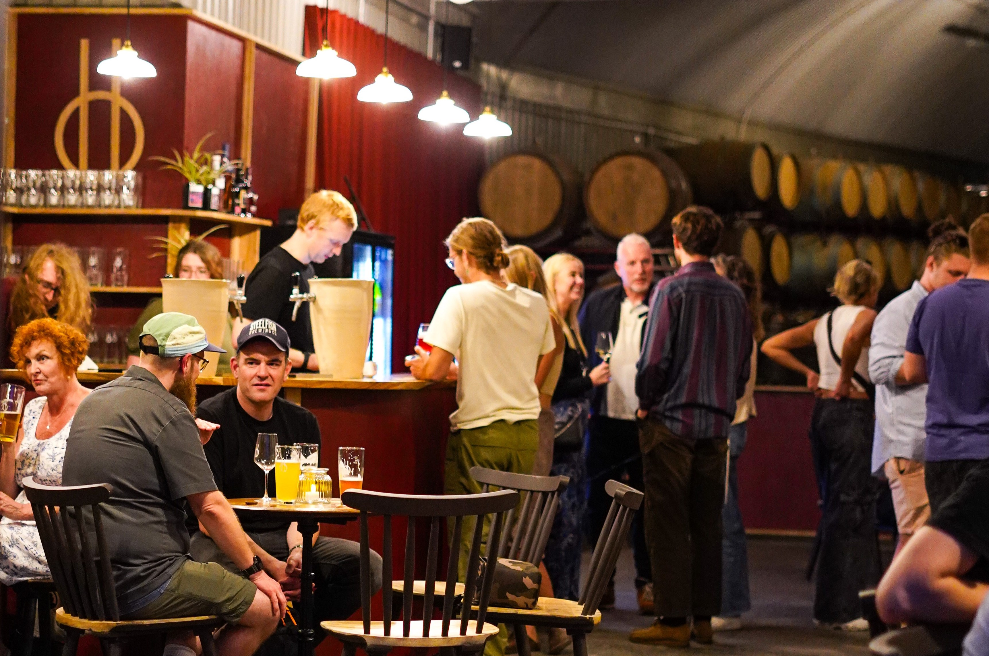 Guests seated in a bar interior.